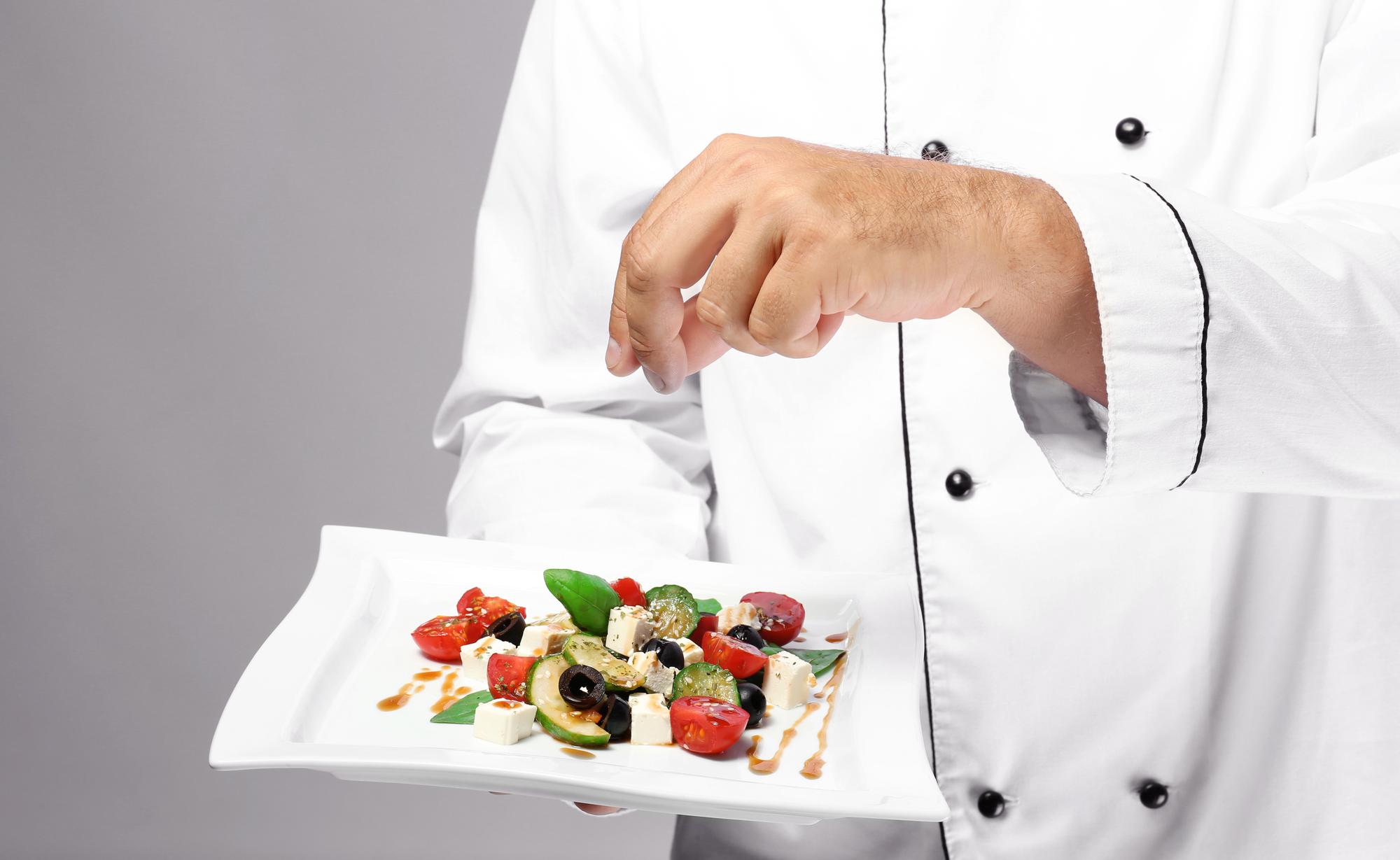 Chef demonstrating plating technique in workshop